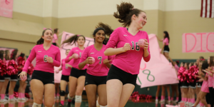 Lisa Alexander and her teammates running on the volleyball court.