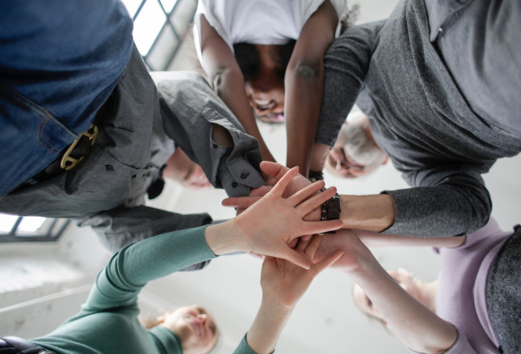 office team with hands in huddle